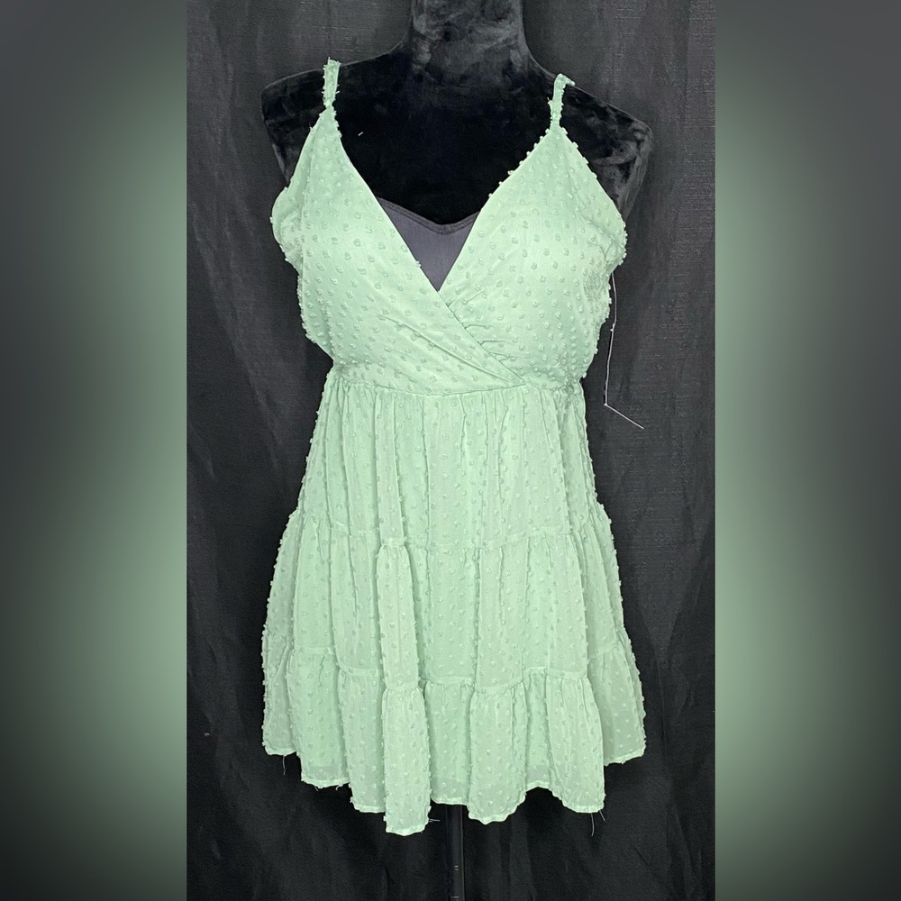 V-neck with straps tiered with ruffle hem and clip dot pattern.